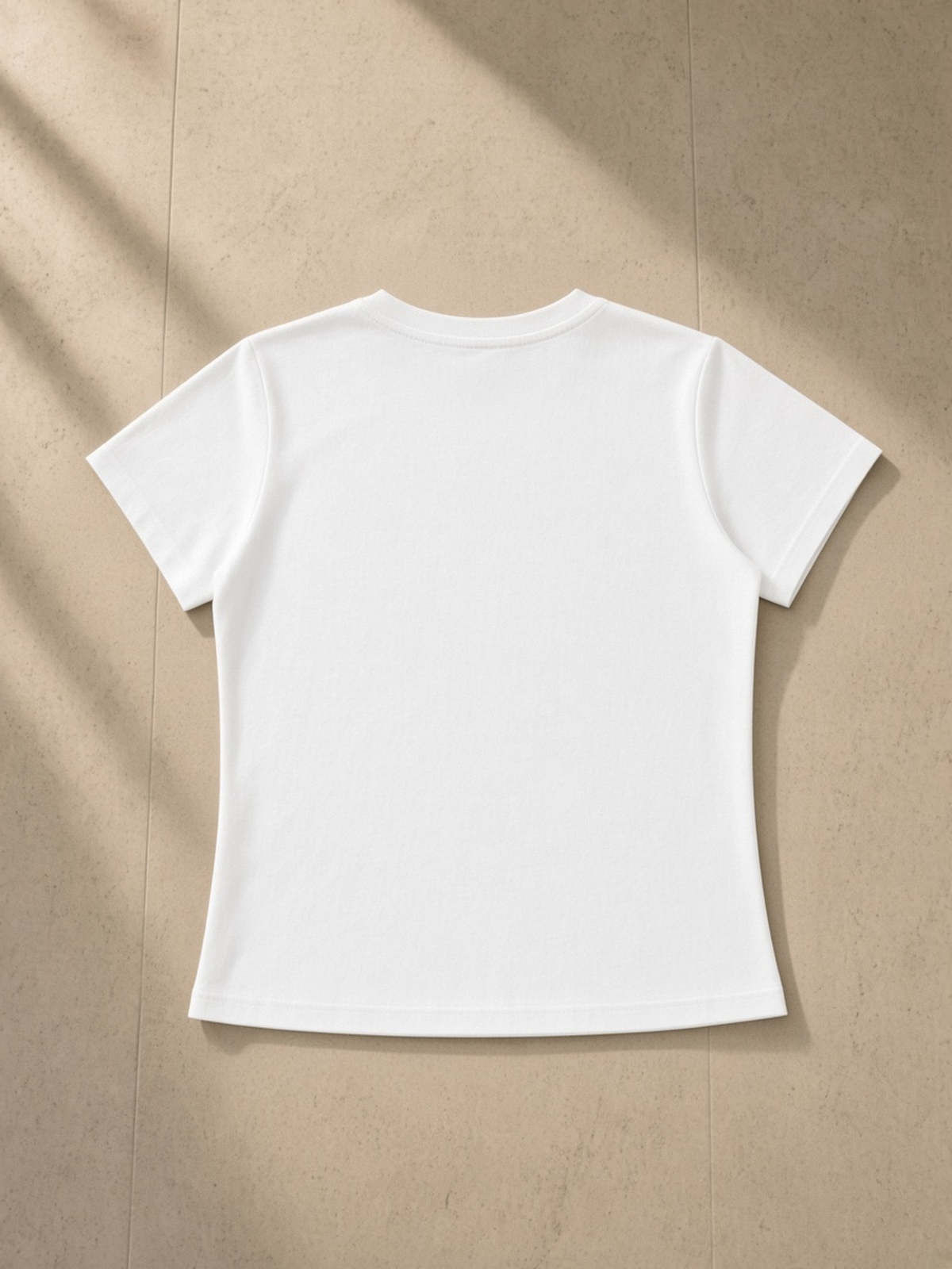 Vintage Wash Slim Fit T-shirt in White, laid flat on pale limestone, back.