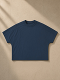 Unisex boxy tonal paneling t-shirt in Navy Blue, laid flat on pale limestone