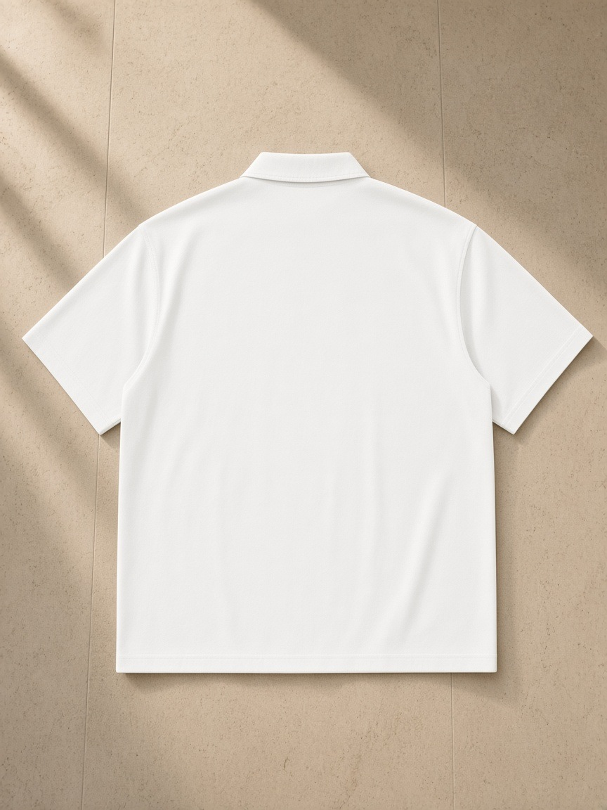 Lightweight Cotton Short Sleeve Shirt in White, laid flat on pale limestone, back view
