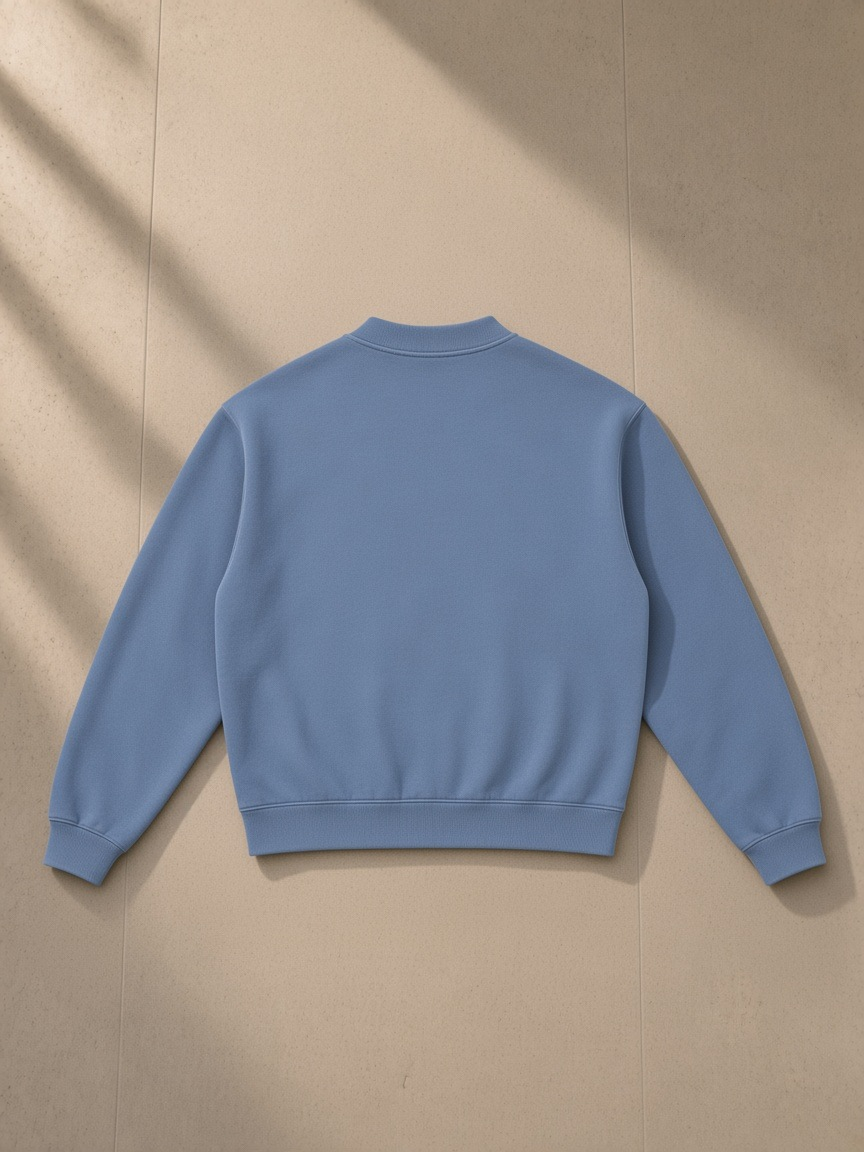 Unisex vintage wash fleece quarter zip sweatshirt in Blue, laid flat on pale limestone, back view