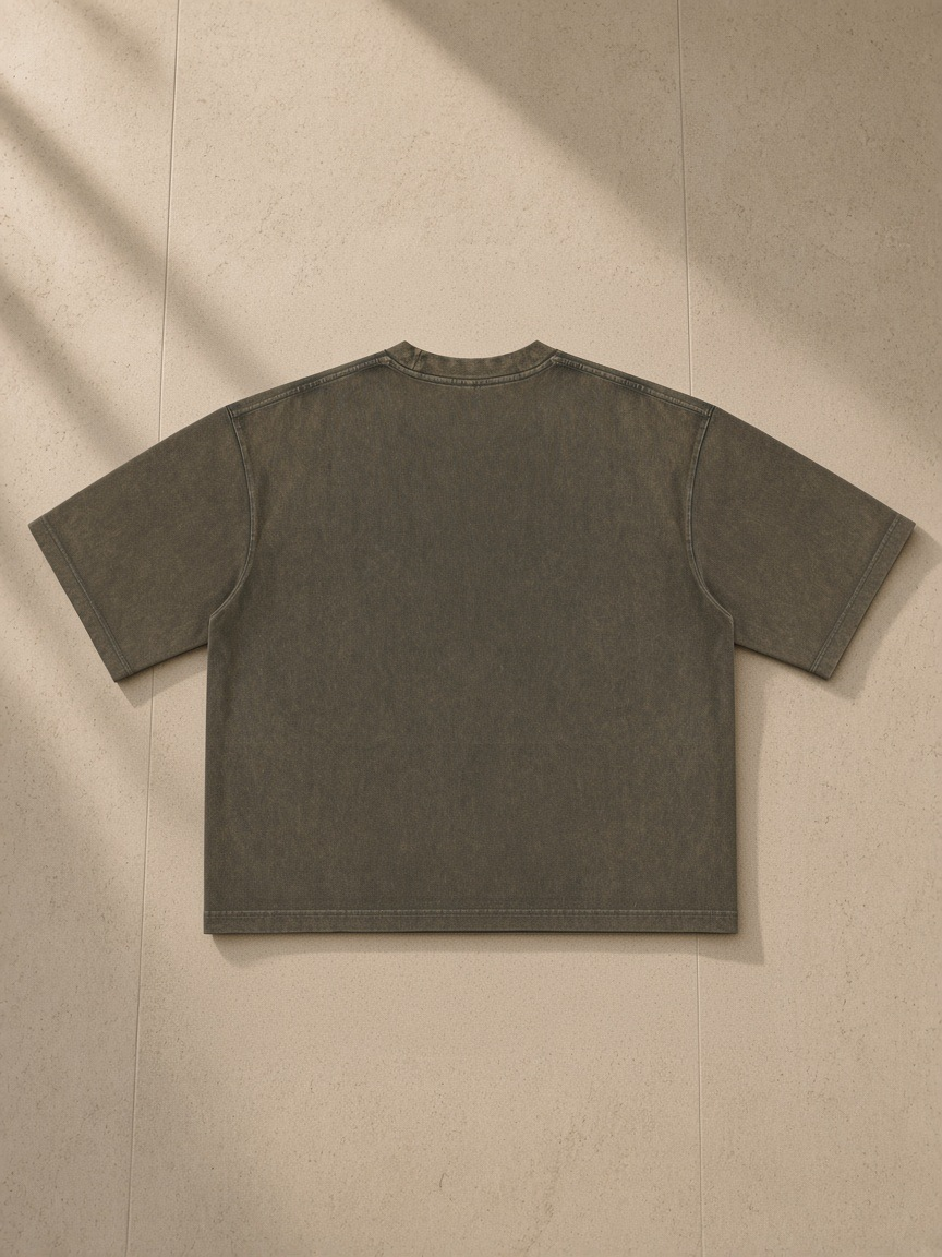 Men's Heavyweight Mineral Wash Boxy T-Shirt in Brown, laid flat on pale limestone, back view