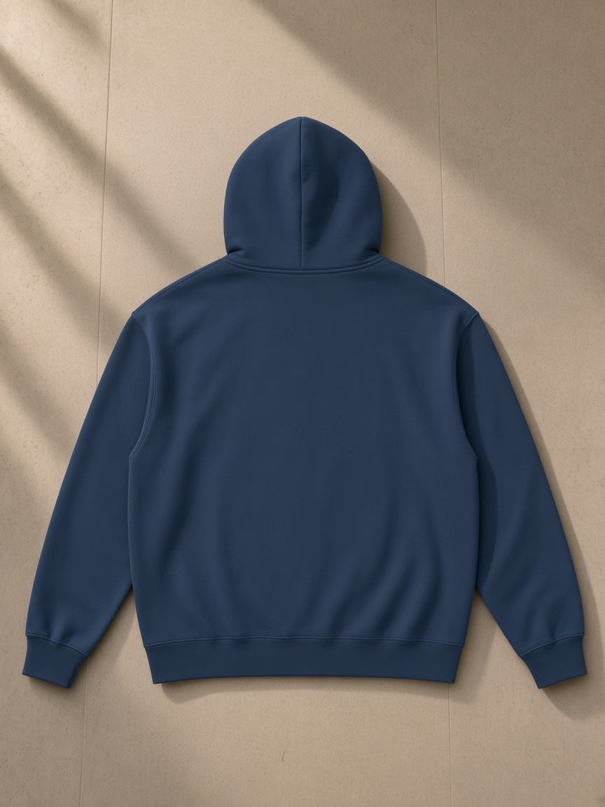 Women's heavyweight full-zip hoodie in Navy Blue, laid flat on pale limestone, back view