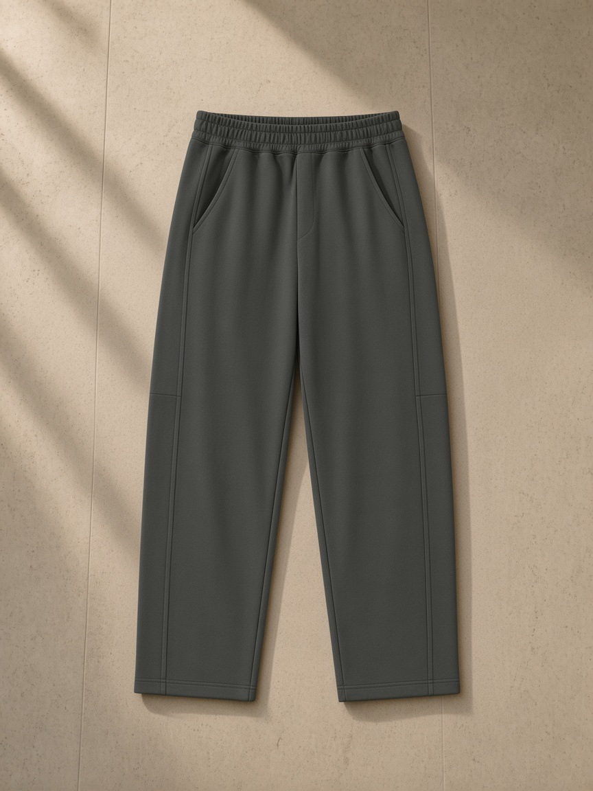 Tapered straight hem sweatpants in Dark Gray over a bouclé armchair in a Paris palace suite at night