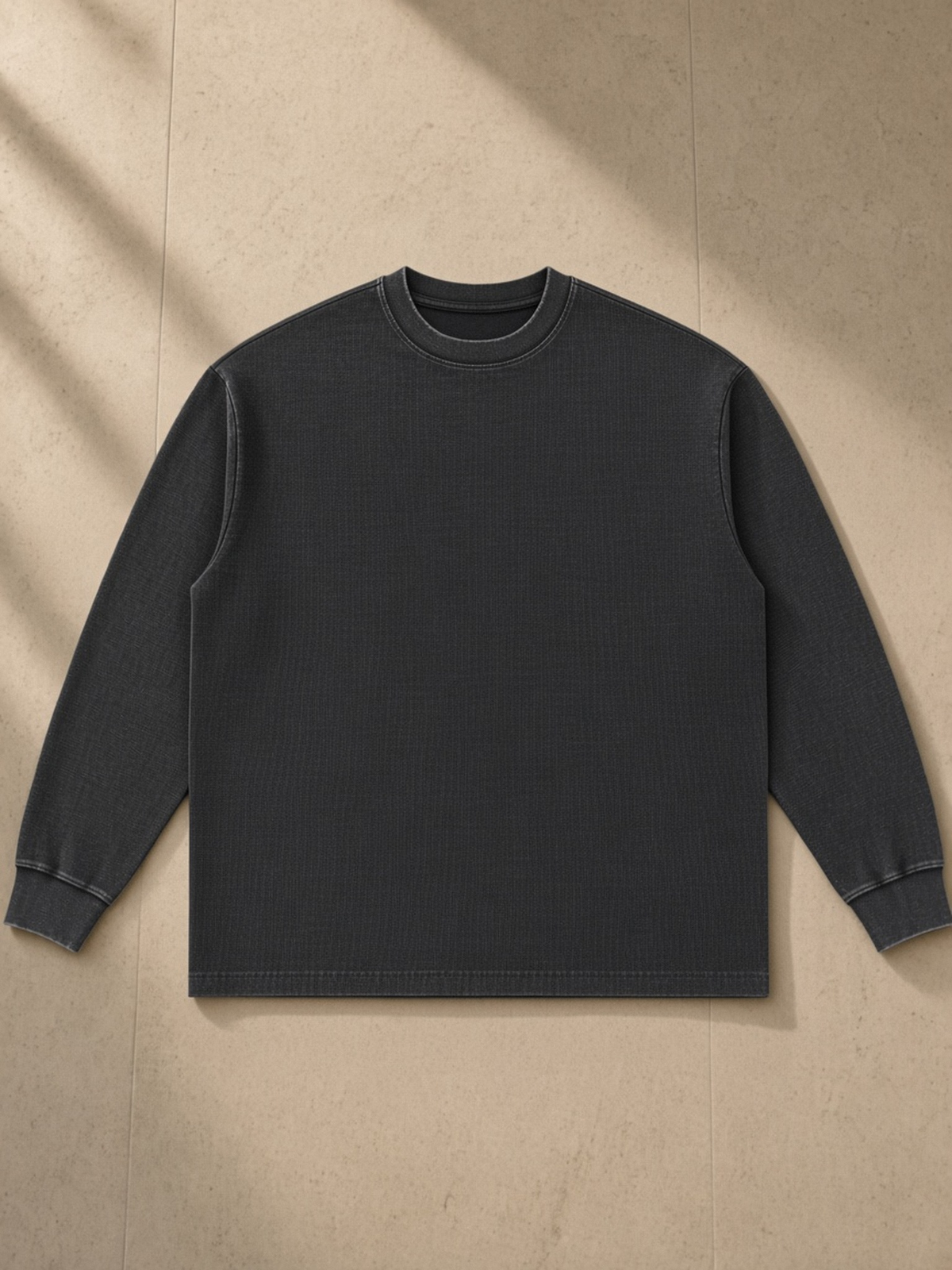 Mineral Wash Waffle Oversized T-Shirt in Black, laid flat on pale limestone, front.