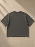 Unisex mineral wash boxy waffle t-shirt in Gray, laid flat on pale limestone