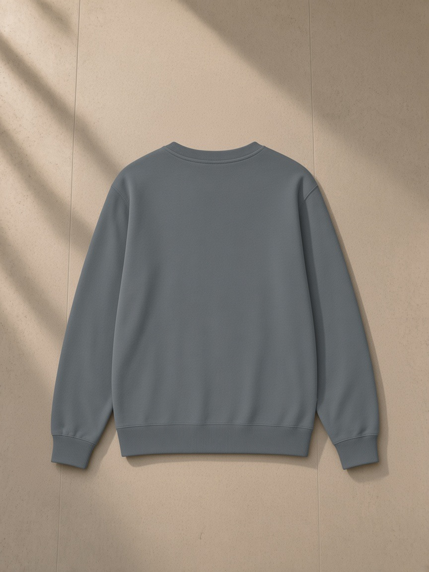 Classic Cotton Sweatshirt in Dark Grey, laid flat on pale limestone, back view