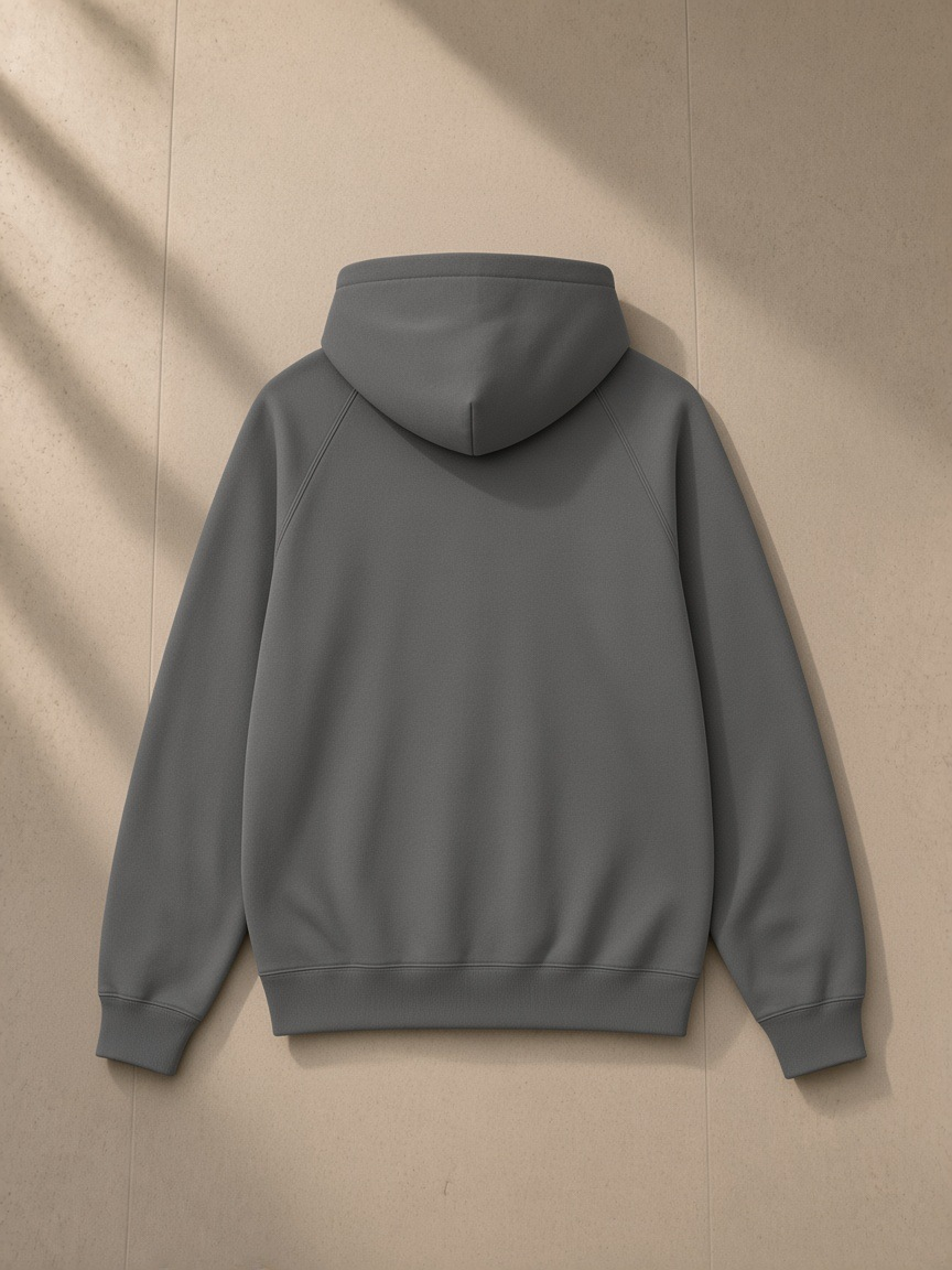 Essential zip-up fleece hoodie in Cement Gray, laid flat on pale limestone, back view