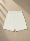 Unisex regular fit shorts in White Gray, laid flat on pale limestone