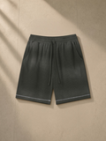 Sunfade waffle raw hem shorts in Gray Green, laid flat on pale limestone