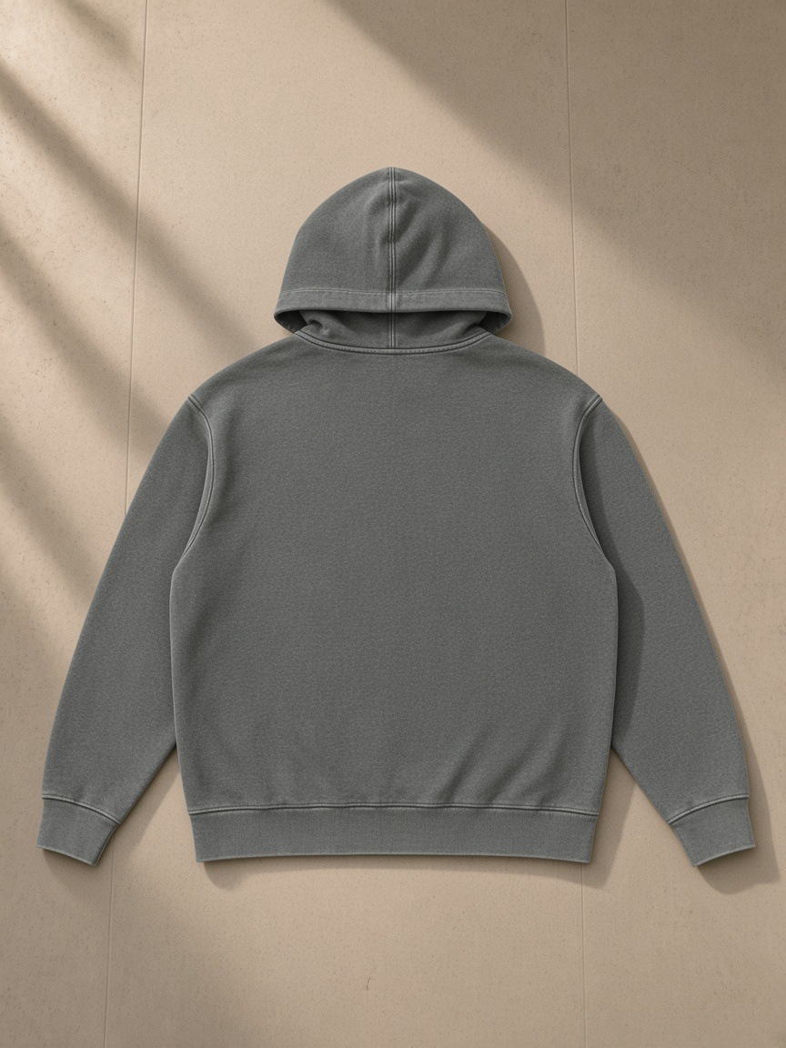 Mineral Wash Oversized Hoodie in Gray, laid flat on pale limestone, back view