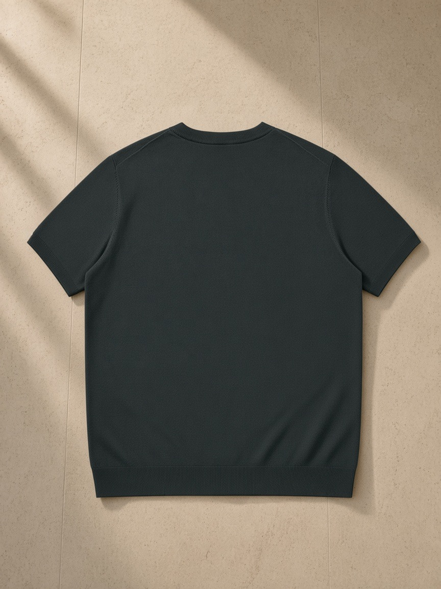 Crewneck Knit T-Shirt in Dark Gray, laid flat on pale limestone, back view