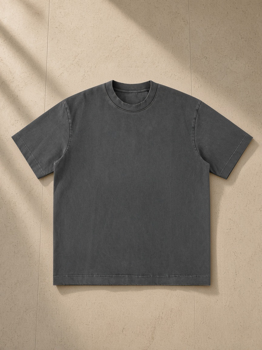 Men's heavyweight vintage washed frayed t-shirt in Dark Gray, laid flat on pale limestone