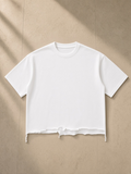 Unisex snow wash raw-hem boxy t-shirt in Washed White, laid flat on pale limestone