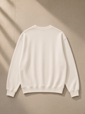 Unisex knitted round neck oversize sweatshirt in White, laid flat on pale limestone, back view