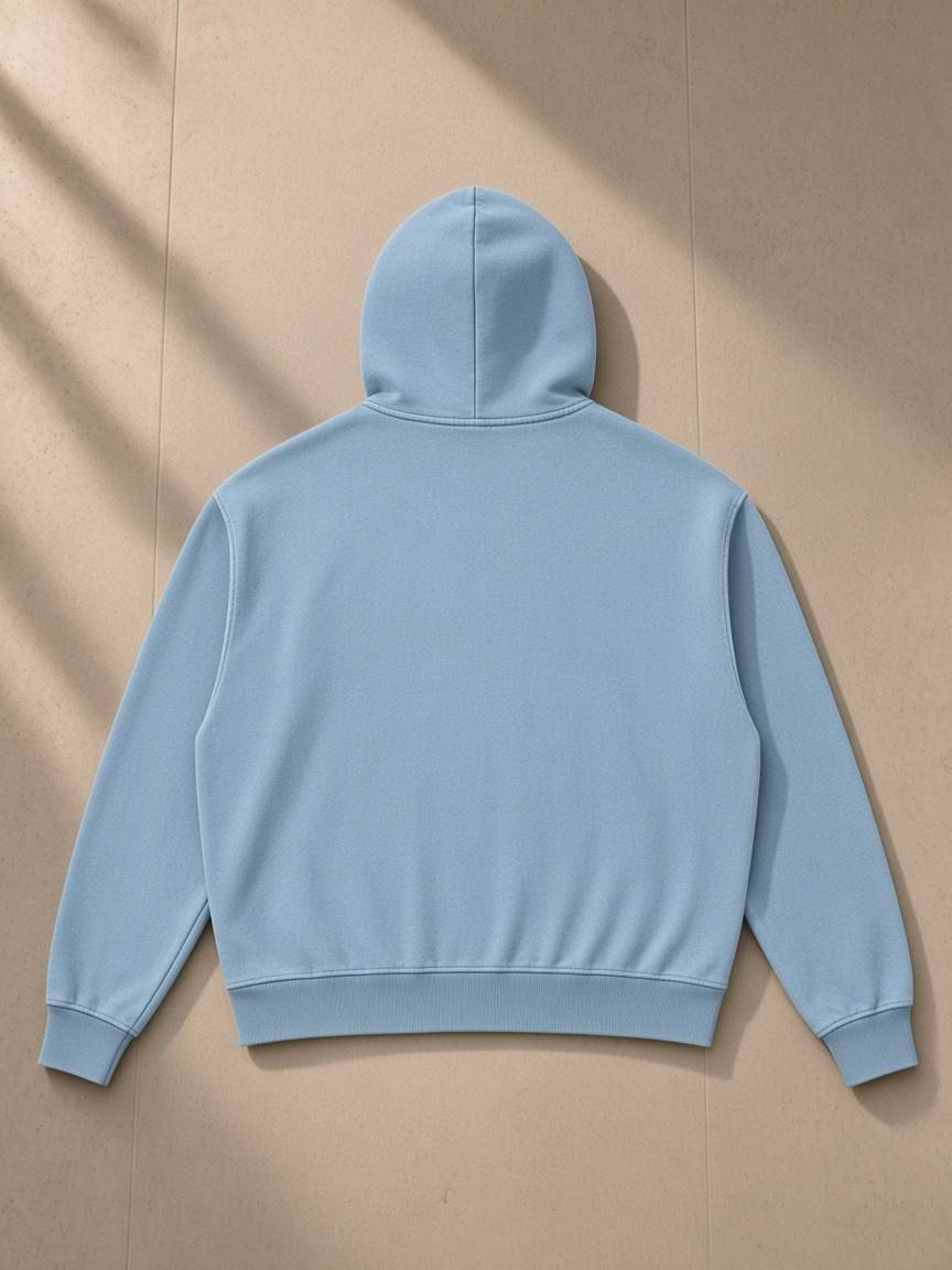 Mineral Wash Boxy Full Zip Hoodie in Haze Blue, laid flat on pale limestone, back view
