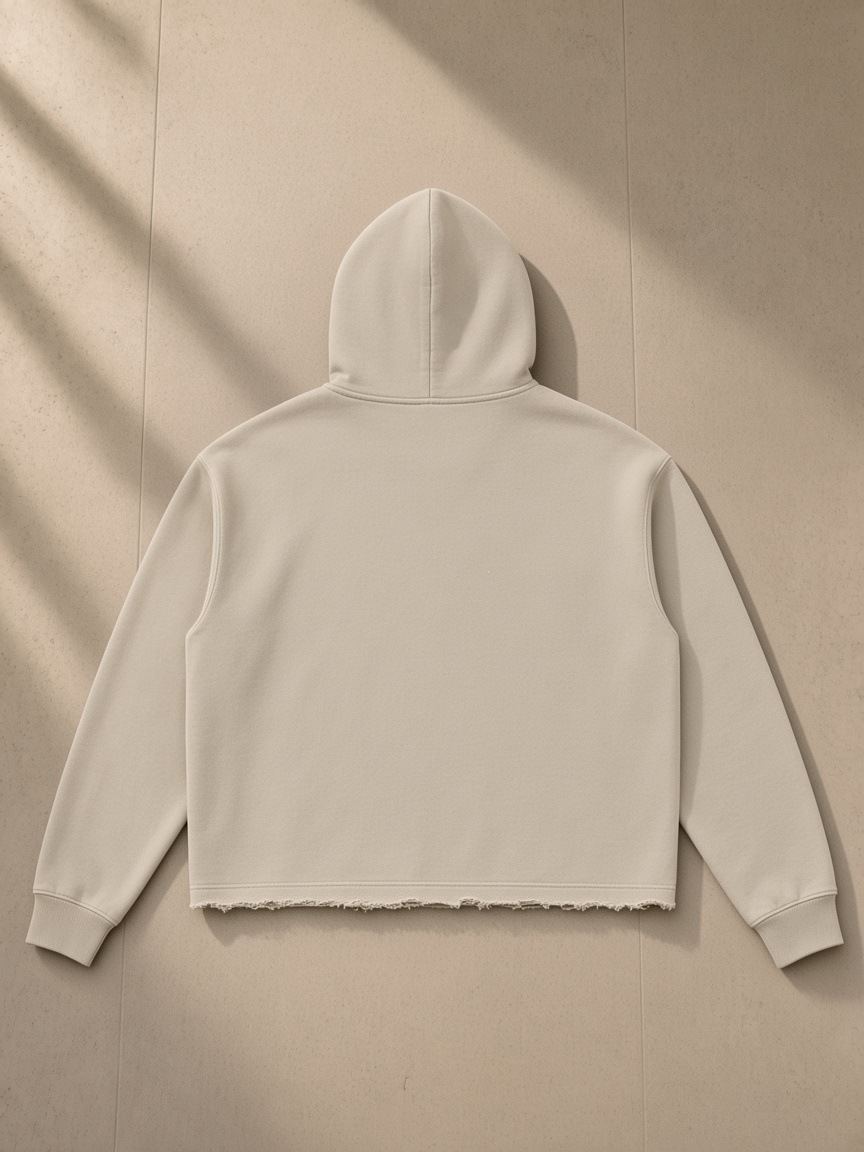 Vintage washed frayed-hem hoodie in Gray Camel, laid flat on pale limestone, back view