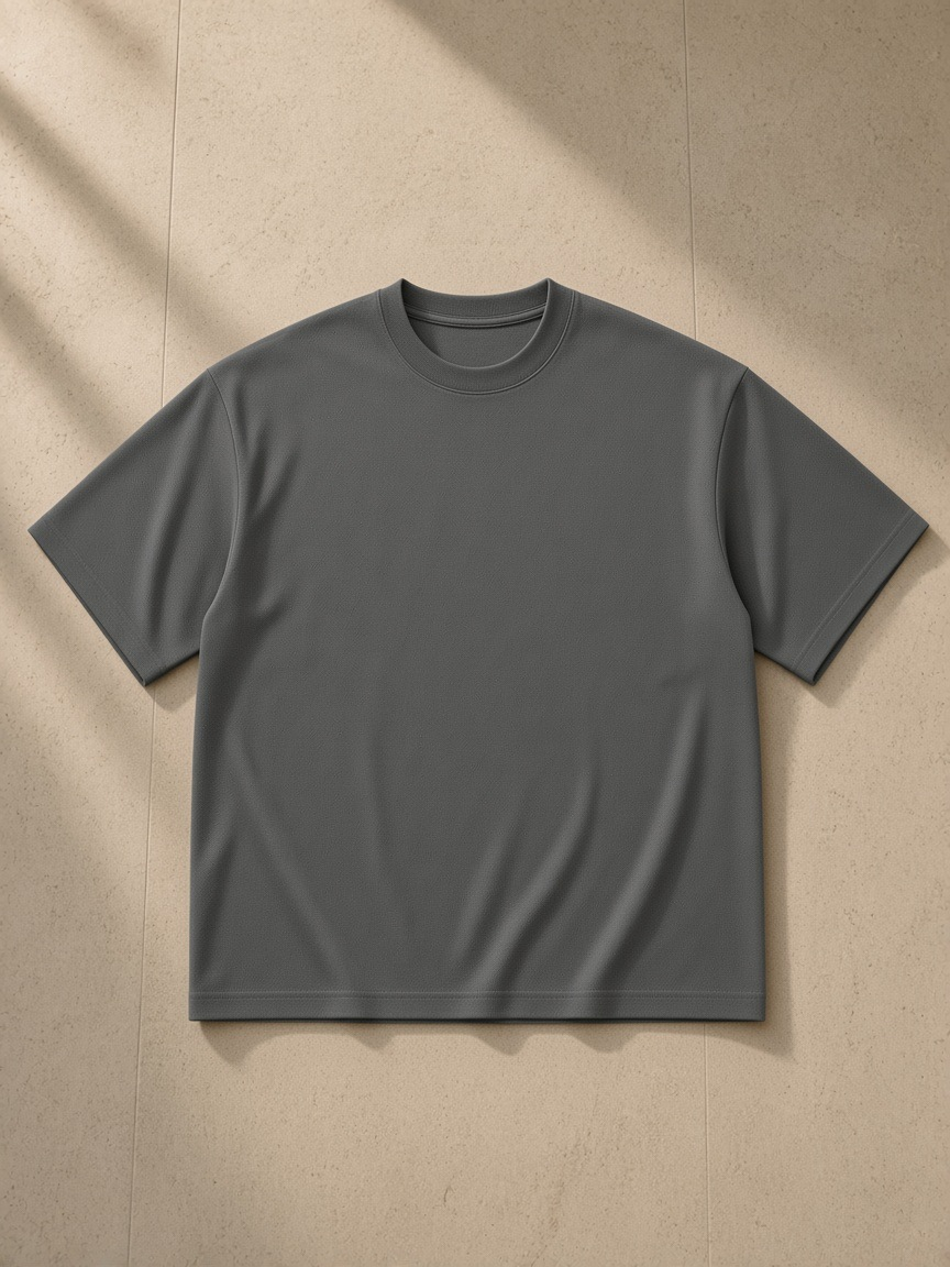 Unisex boxy mesh crewneck t-shirt in Dark Gray, laid flat on pale limestone