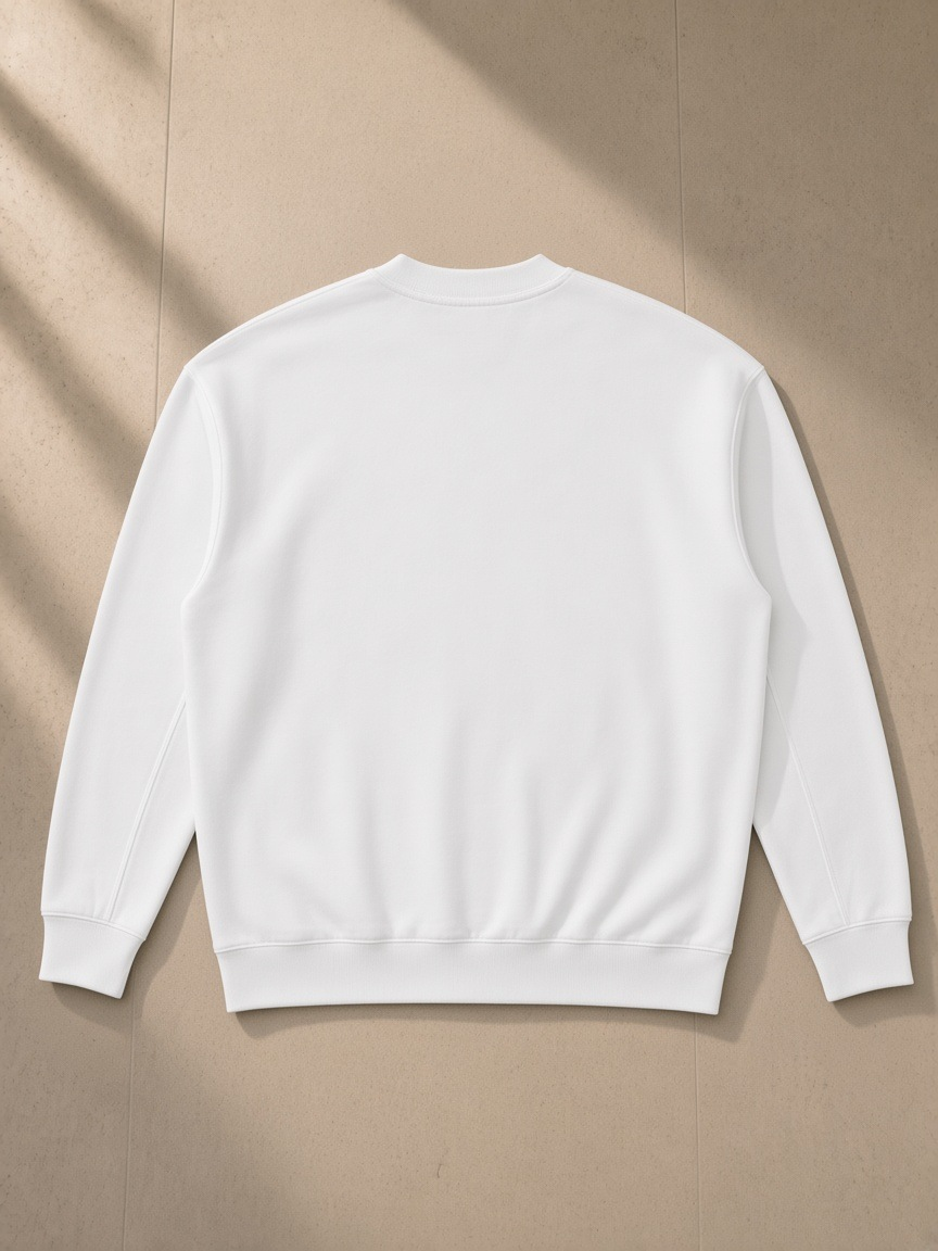 Drop Shoulder Crewneck Sweatshirt in White, laid flat on pale limestone, back view