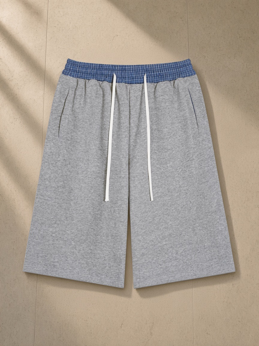 Plaid Waistband Shorts in Flower Gray, laid flat on pale limestone
