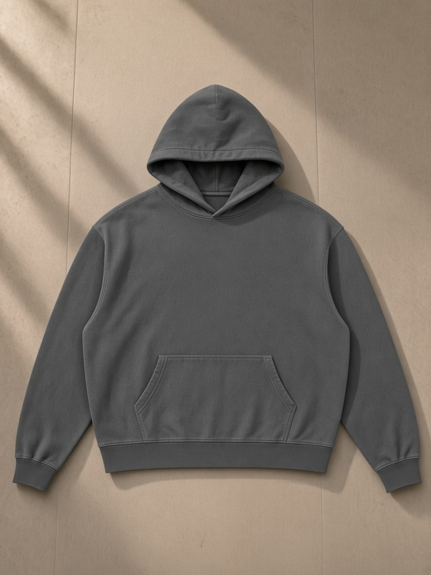 Vintage Wash Boxy Hoodie in Dark Gray, laid flat on pale limestone, front.