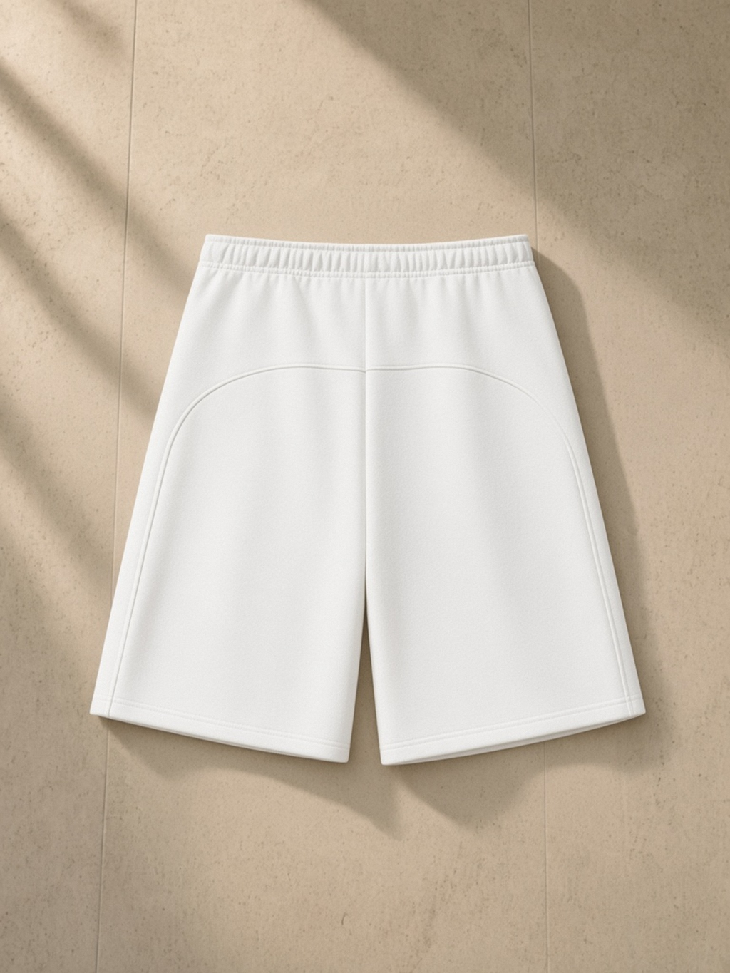 Essential Heavyweight Fleece Shorts in White, laid flat on pale limestone, back.