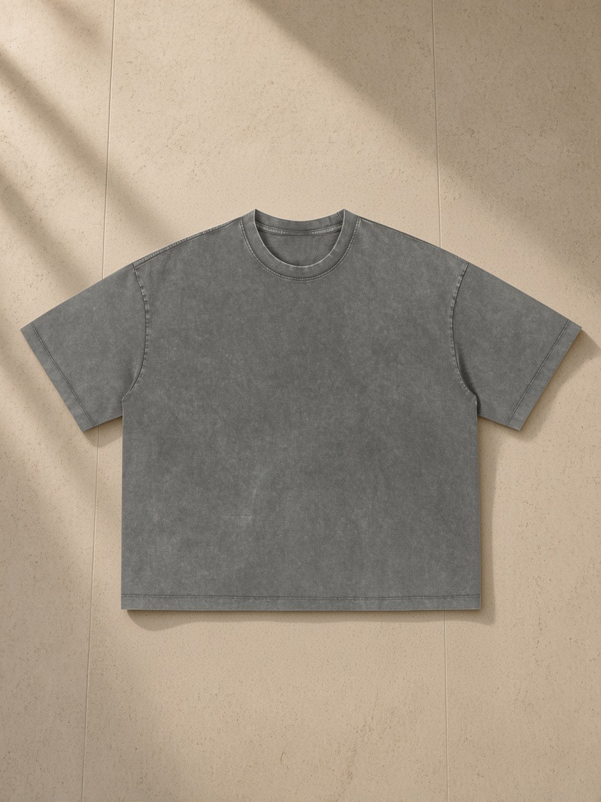 Unisex vintage wash boxy t-shirt in Dark Gray, laid flat on pale limestone