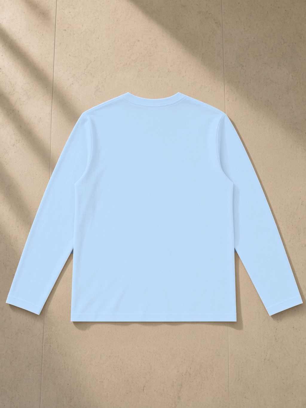 Heavyweight Long Sleeve T-Shirt in Sky Blue, laid flat on pale limestone, back.