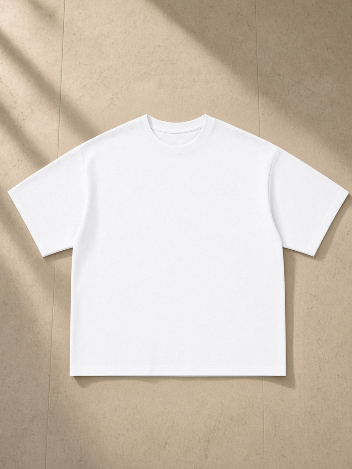 Essential Sorona Boxy T-Shirt in White, laid flat on pale limestone, front.