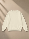 Unisex heavyweight drop shoulder sweatshirt in Bone, laid flat on pale limestone