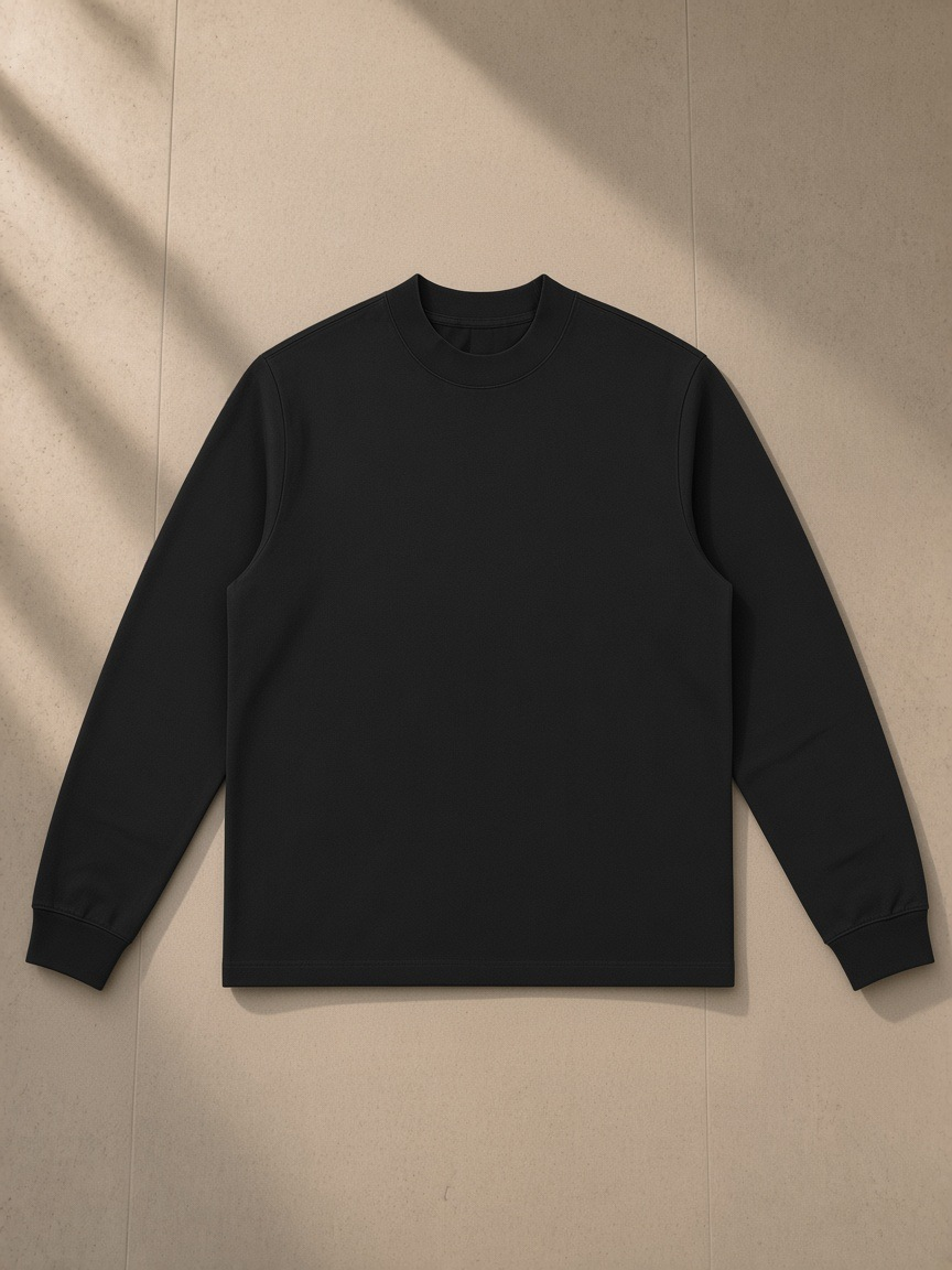 Mock Neck Sweatshirt in Black, laid flat on pale limestone