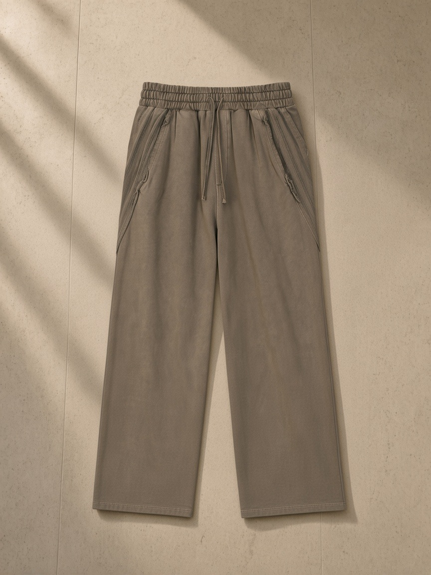 Snow Washed Tape Raw Edge Sweatpants in Khaki, laid flat on pale limestone, front.