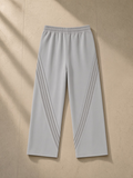 Snow Washed Tape Raw Edge Sweatpants in Light Gray, laid flat on pale limestone, back view