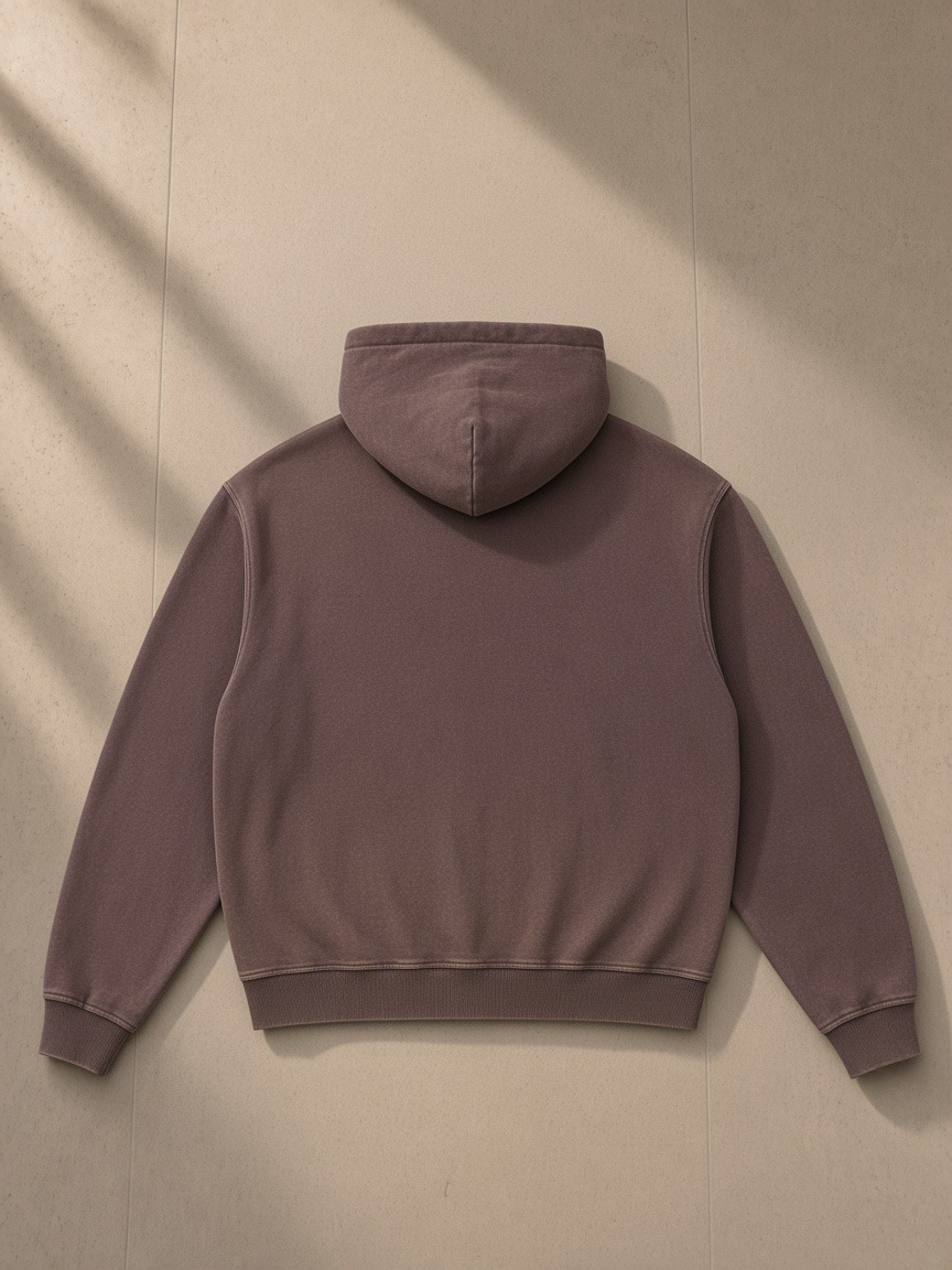 Vintage washed gradient fleece hoodie in Brown, laid flat on pale limestone, back view