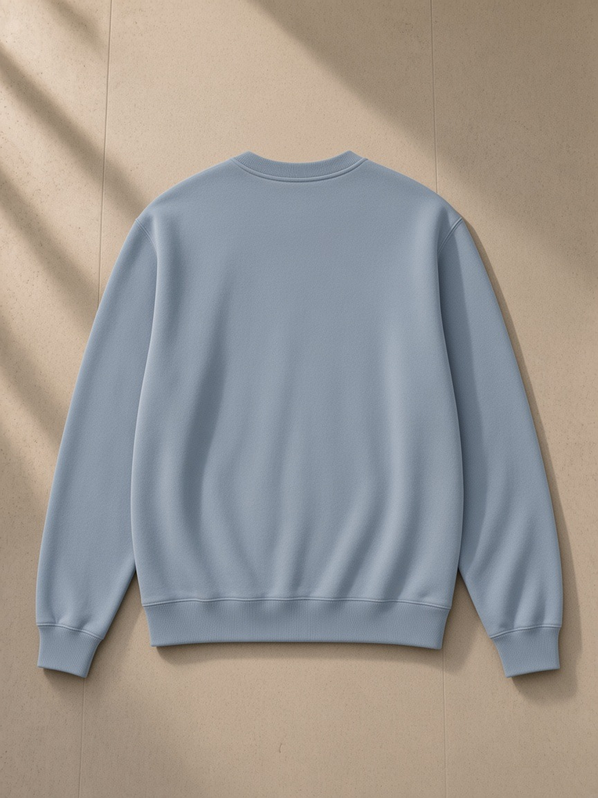 Classic Cotton Sweatshirt in Haze Blue, laid flat on pale limestone, back view