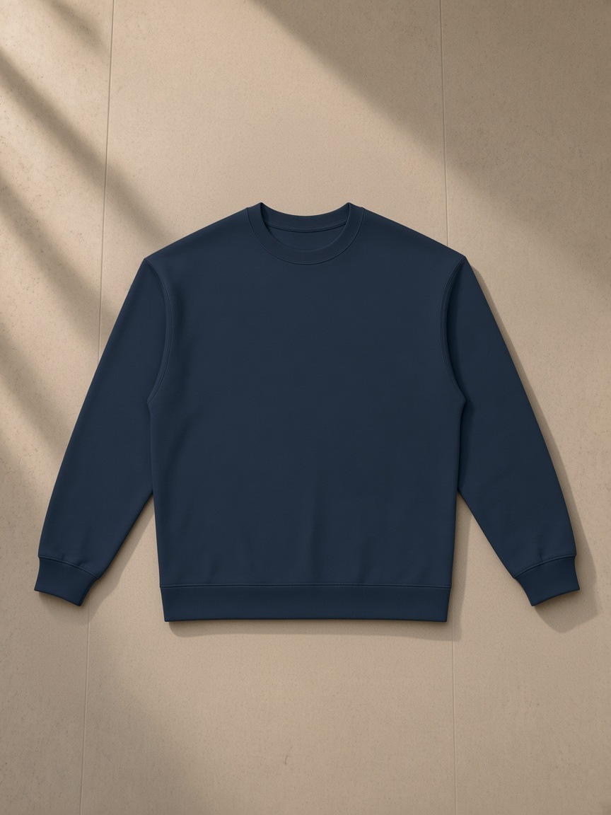 Oversized Crewneck Sweatshirt in Navy Blue, laid flat on pale limestone