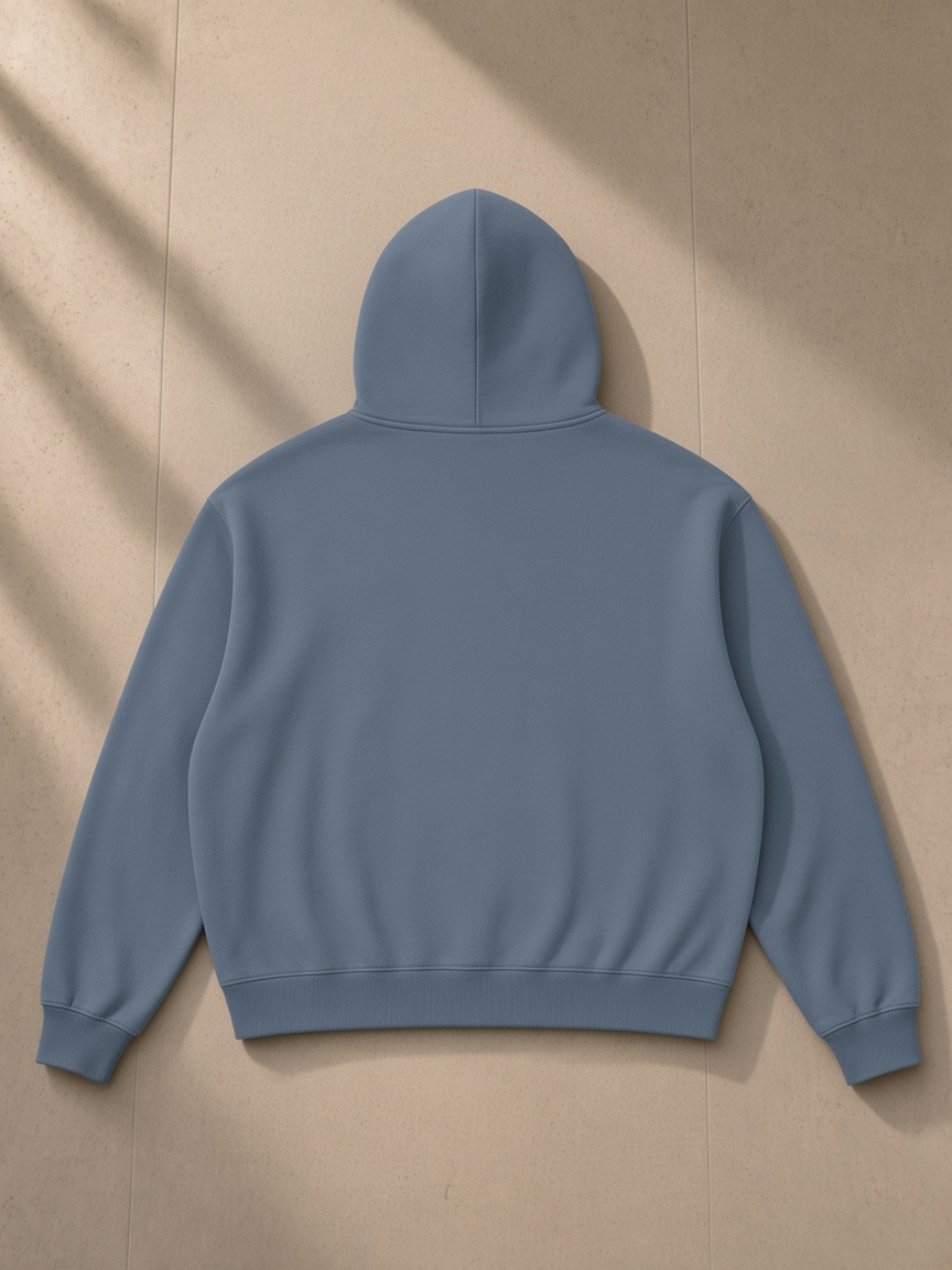 Vintage Wash Boxy Full Zip Hoodie in Gray Blue, laid flat on pale limestone, back view