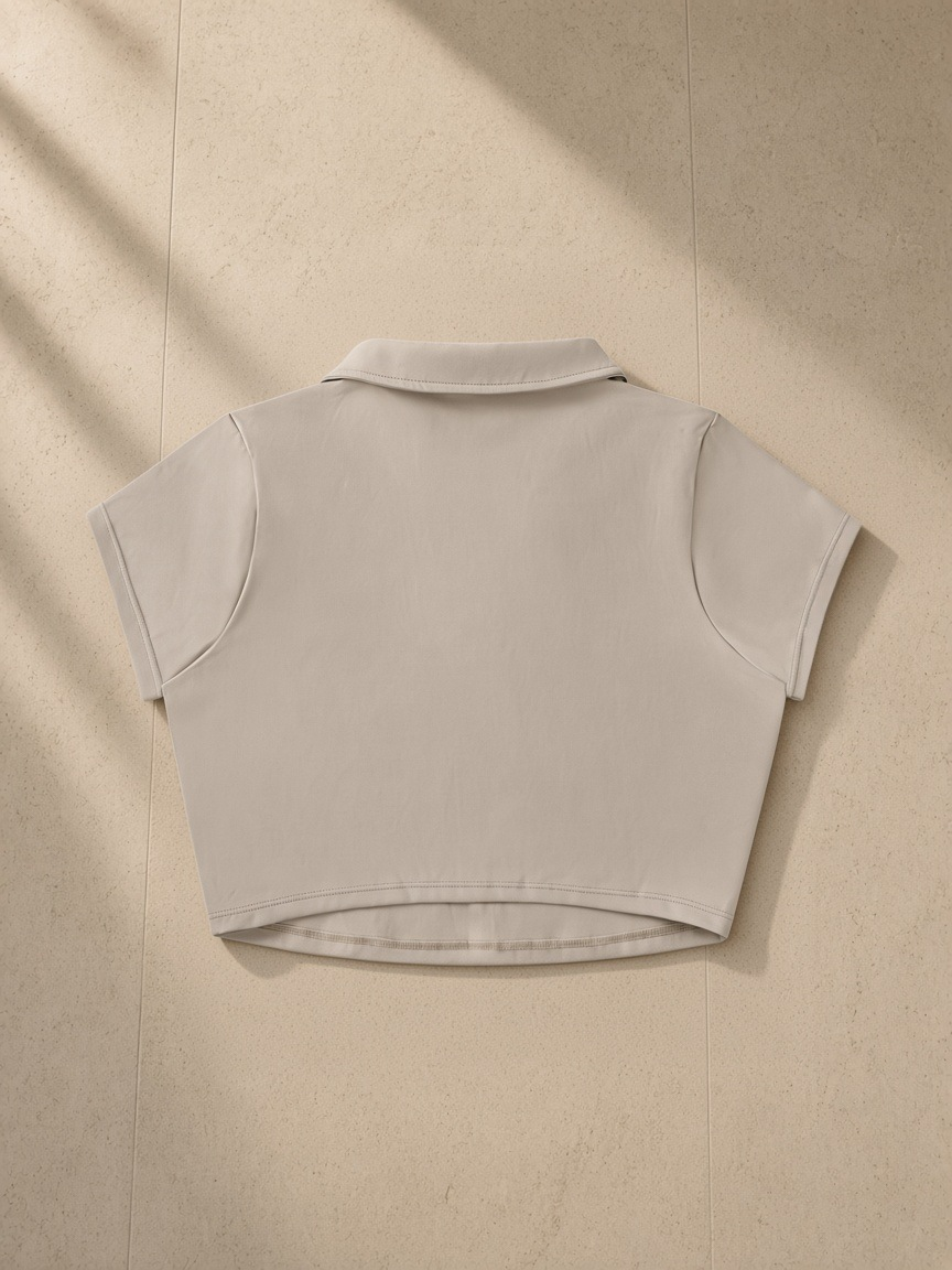 V-Neck Lapel Crop Top in Light Coffee, laid flat on pale limestone, back view