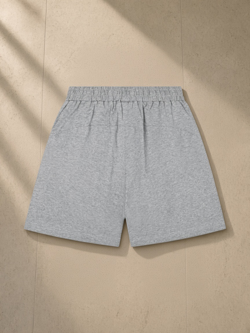 Unisex regular fit shorts in Flower Gray, laid flat on pale limestone, back view