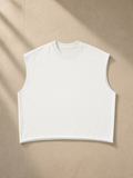 Men's French Terry Boxy Tank Top in White, laid flat on pale limestone