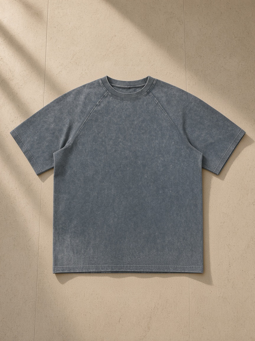 Unisex mineral wash raw edge t-shirt in Medium Gray, front view on white. Marcel Afters