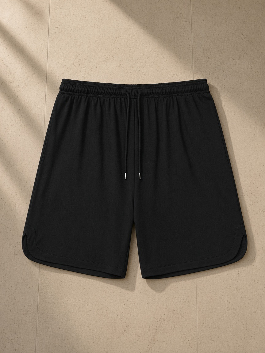 Mesh-Lined Quick-Dry Performance Shorts in Black, laid flat on pale limestone