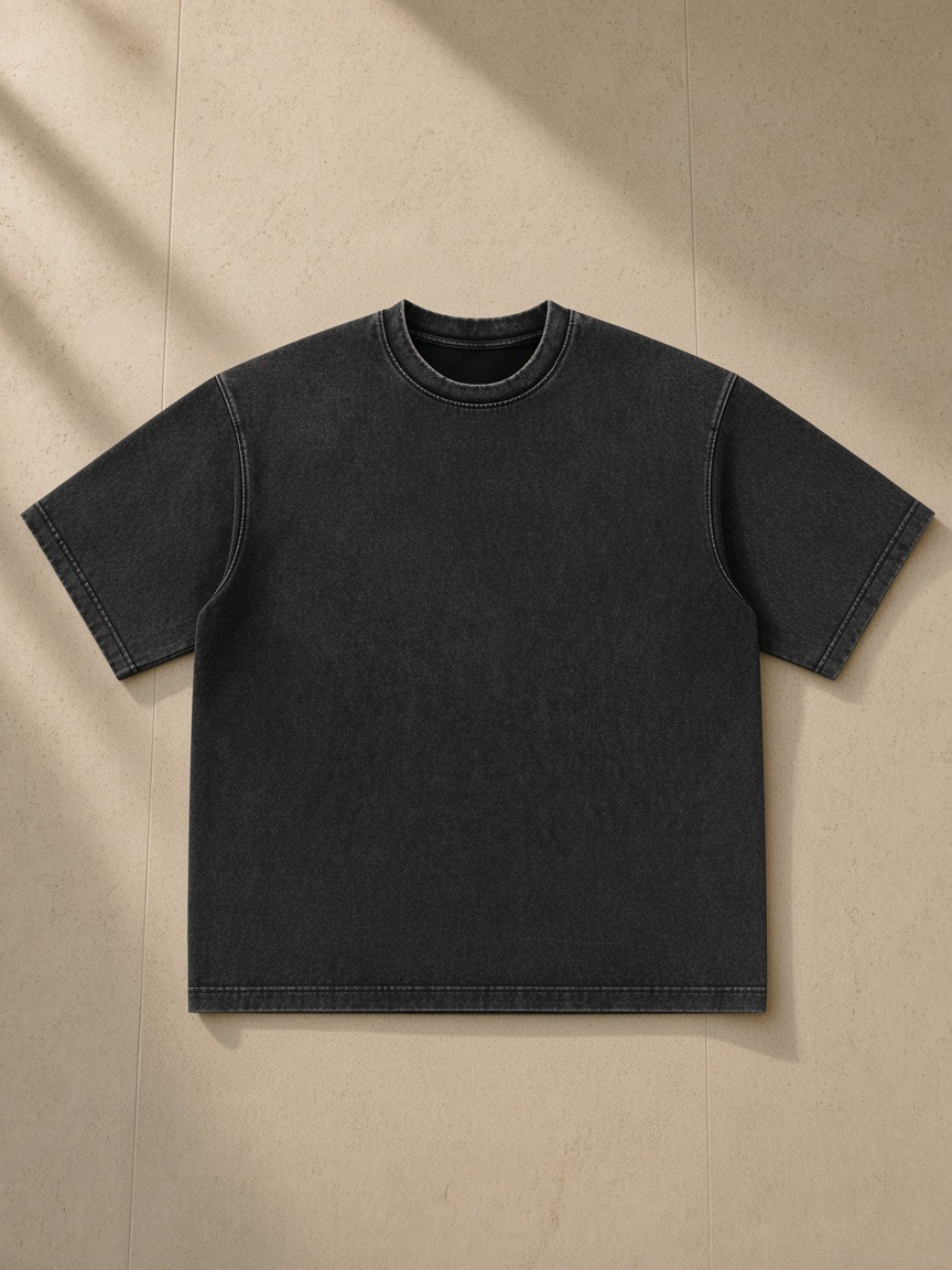 Women's Heavyweight Mineral Wash Boxy T-Shirt in Black, laid flat on pale limestone