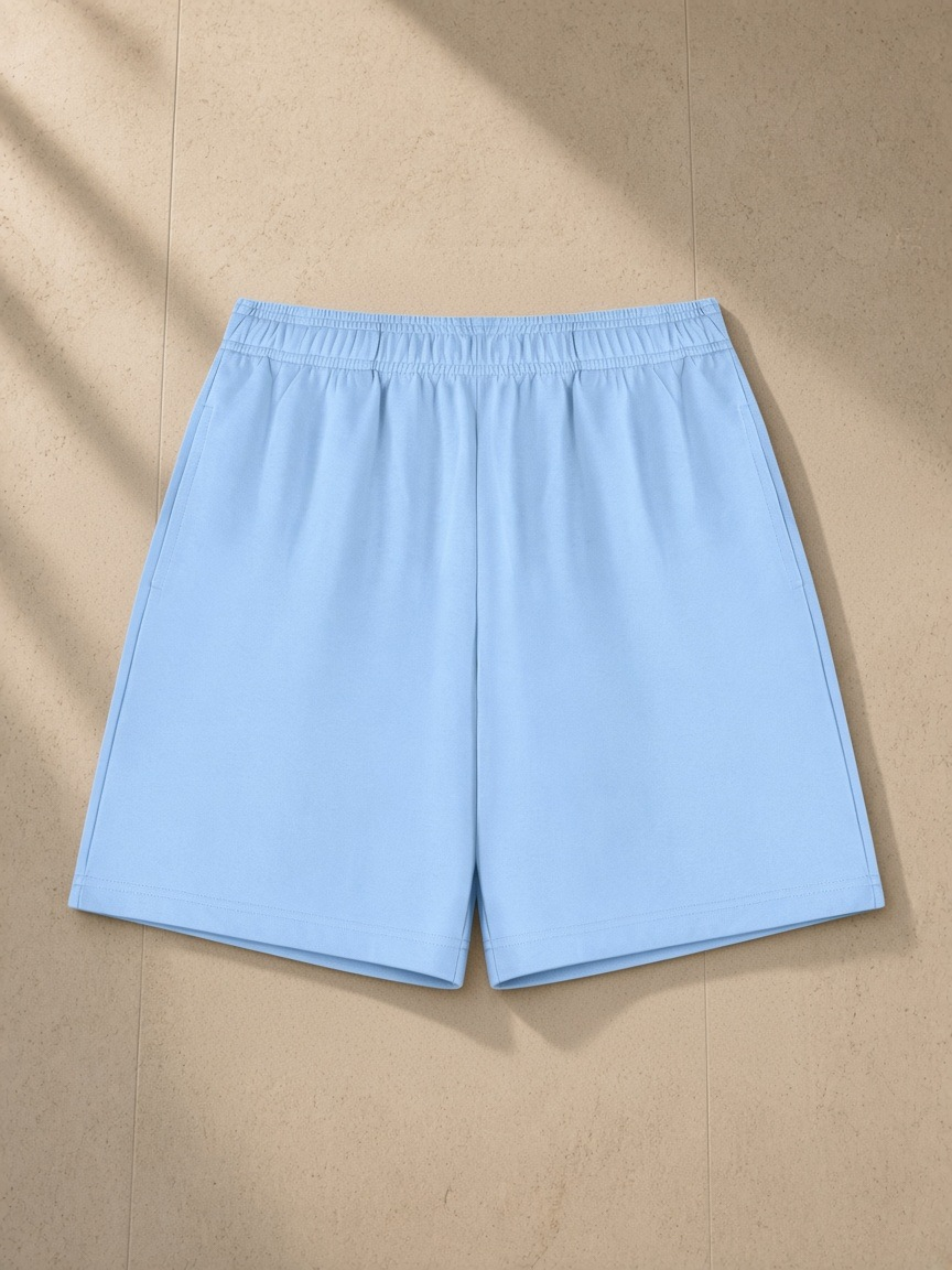 Cotton Shorts in Sky Blue, laid flat on pale limestone