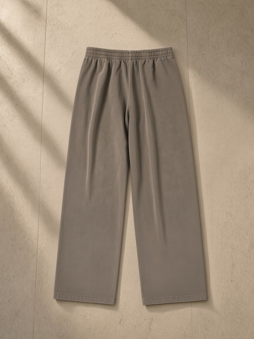 Vintage Washed Waist Pants in Coffee, laid flat on pale limestone, back.