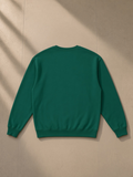 Loose Crewneck Sweatshirt in Dark Green, laid flat on pale limestone, back view
