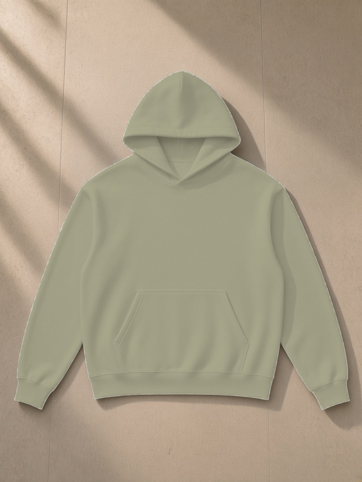 Essential Heavyweight Drop-Shoulder Hoodie in Gray Green, laid flat on pale limestone, front.
