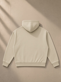 Unisex heavyweight fleece boxy hoodie in Khaki, laid flat on pale limestone, back view
