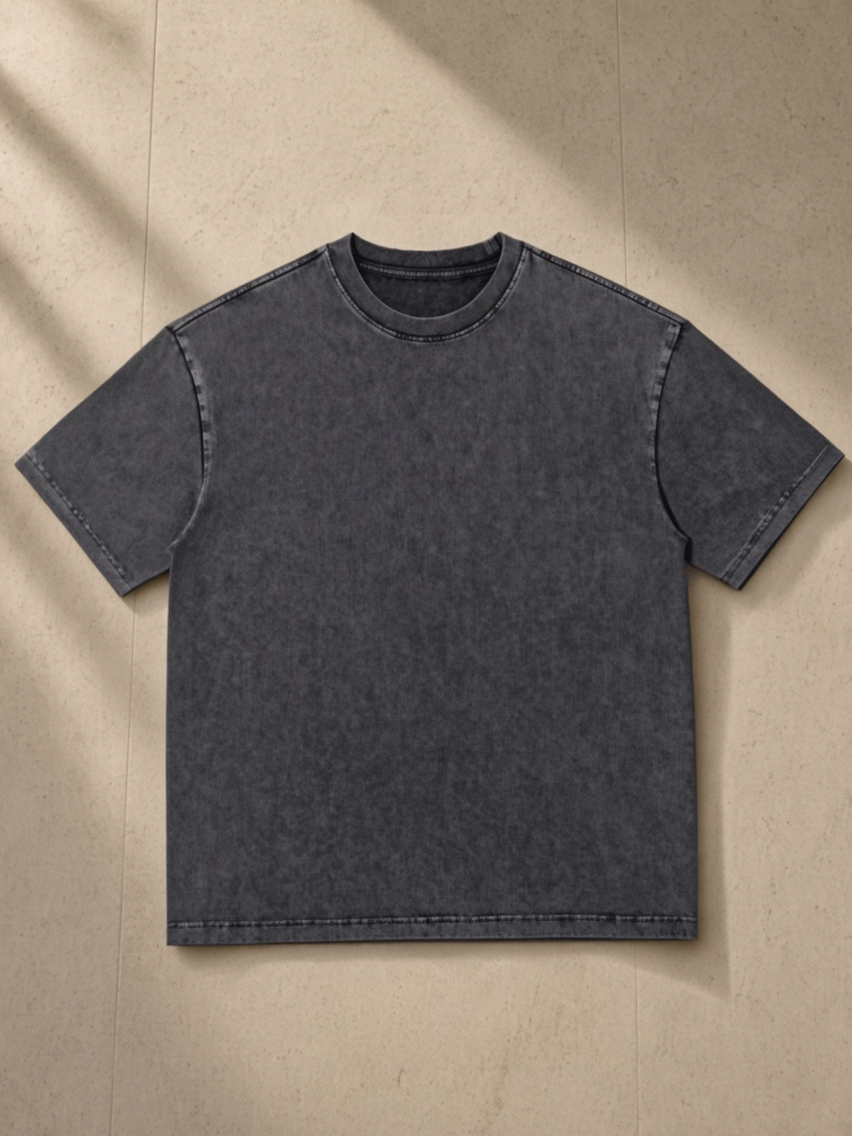 Snow Washed Heavyweight Oversize T-Shirt in Gray, laid flat on pale limestone, front view