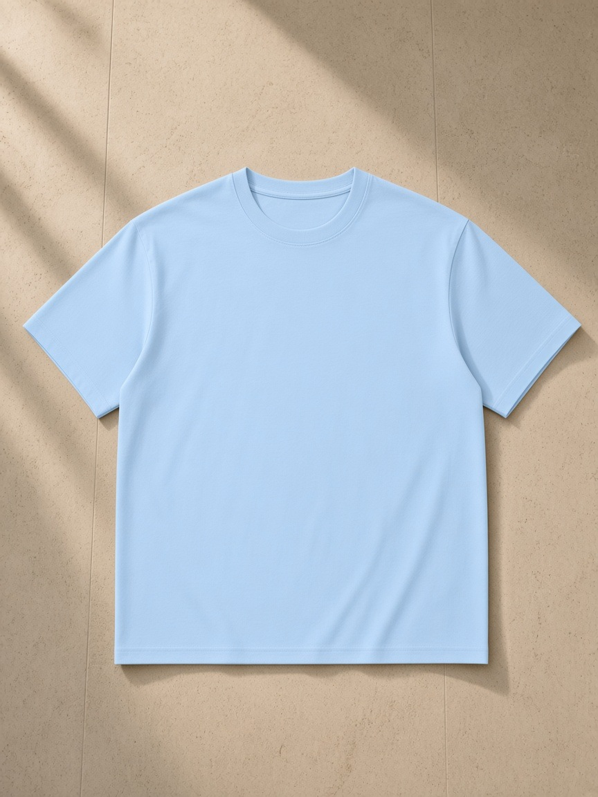 Unisex Regular Fit Coolmax T-Shirt in Sky Blue, laid flat on pale limestone