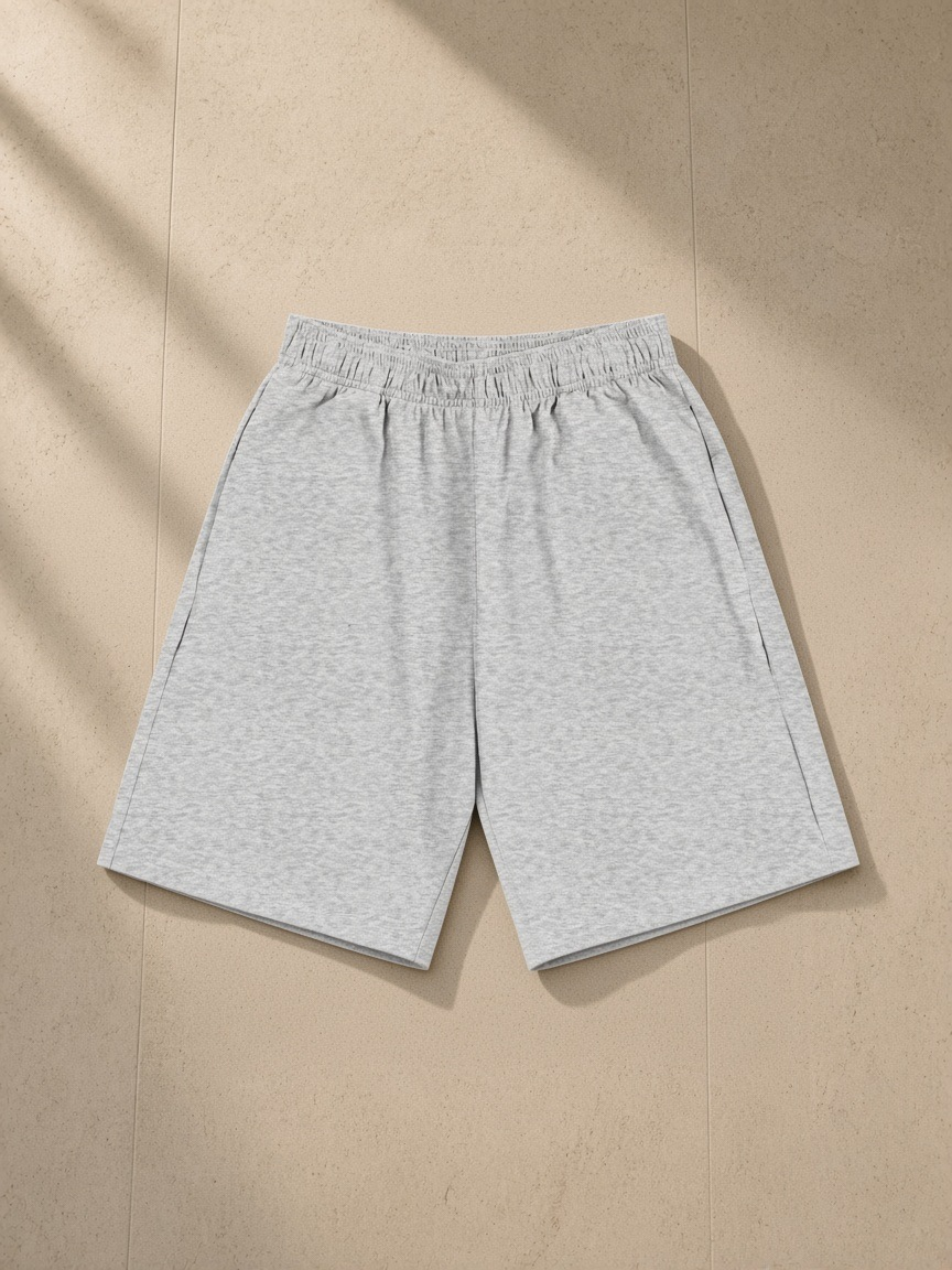 Unisex heavyweight cotton shorts in Flower Gray, laid flat on pale limestone